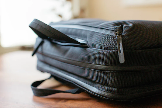 A Versatile Commuter Bag on a wood desk.