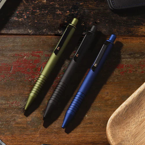 A collection of high-quality everyday carry items for men, including Grafton Everyman Pens on a wooden desk.