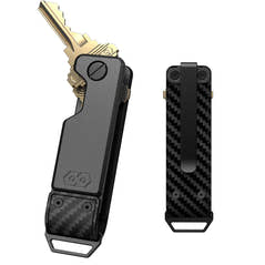 PROOF Oracle key holder front and back: gunmetal aluminum body with brass keys fanned from the pivot, and a woven carbon fiber back panel with pocket clip and steel loop