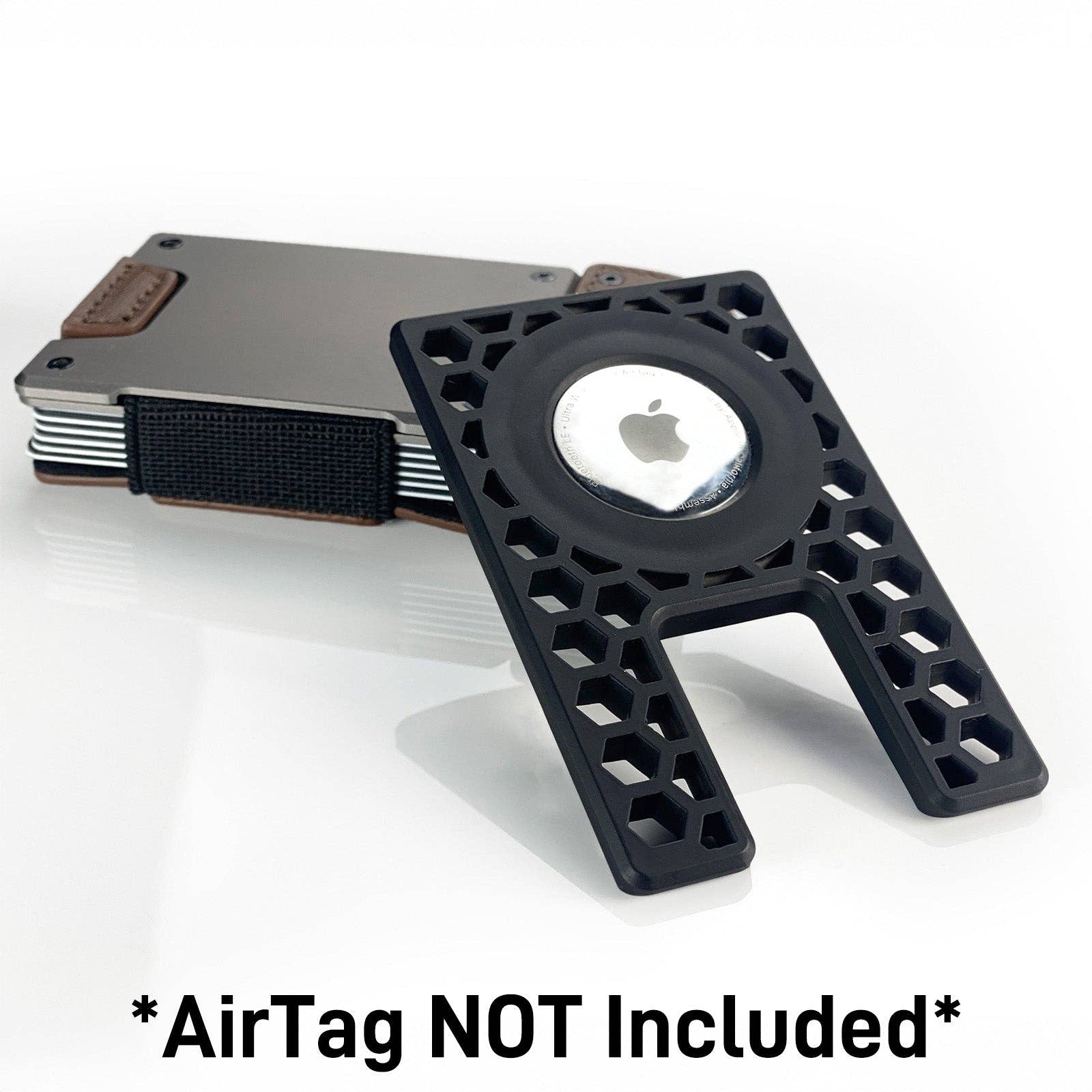 PROOF AirTag holder angled beside a satin gunmetal PROOF wallet with an Apple AirTag seated in the frame, captioned 'AirTag NOT Included'