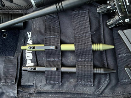 OD Green and Black Super Matte Graftons in the MOLLE webbing of a police vest