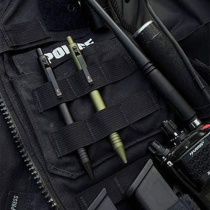 OD Green and Black Super Matte Graftons carried in the MOLLE webbing of a police vest